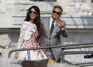 U.S. actor George Clooney and his wife Amal Alamuddin leave the seven-star hotel Aman Canal Grande Venice in Venice